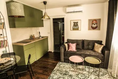a living room with a couch and two tables at Polar Apartments Banja Luka LPIJ in Banja Luka