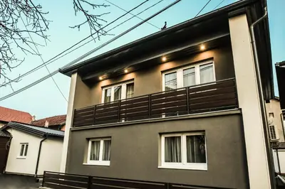 a house with a balcony on the side of it at Polar Apartments Banja Luka LPIJ in Banja Luka