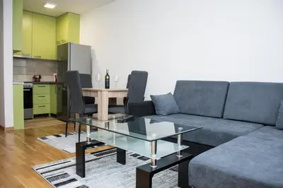 a living room with a couch and a table at Stan na dan Doboj in Doboj