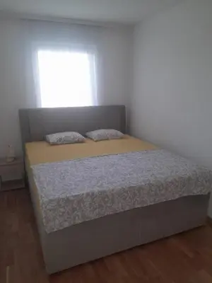 a bed in a bedroom with a window at Stan na dan Doboj in Doboj