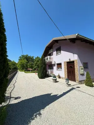 a house with a gravel driveway in front of it at EMRAH RIVER UNA in Bihać