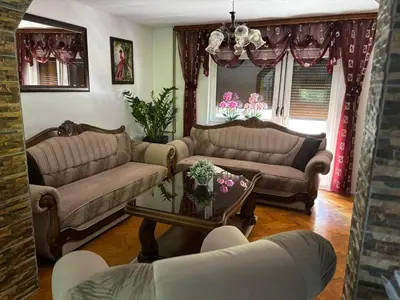 a living room with two couches and a table at EMRAH RIVER UNA in Bihać