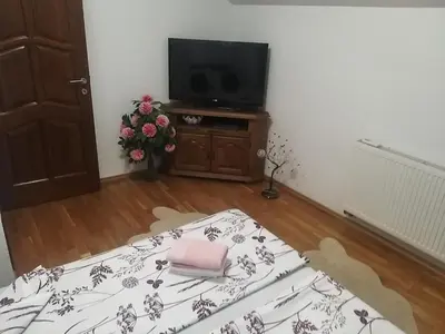 a living room with a television and a table with a pillow at EMRAH RIVER UNA in Bihać