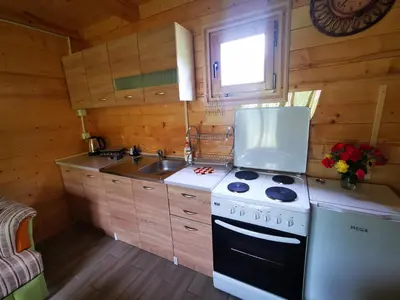 a kitchen with a stove and a sink at Wooden House 