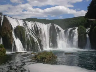 a large waterfall in the middle of a river at Wooden House 