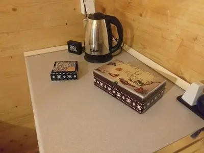 two boxes and a tea kettle on a counter at Wooden House 