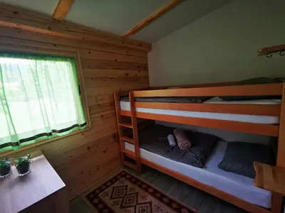a bedroom with bunk beds in a log cabin at Wooden House 