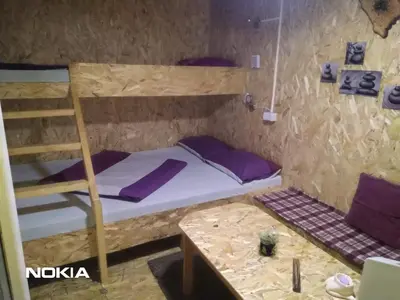 a bedroom with a bunk bed and a table at tree house in Visoko