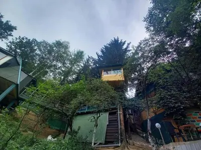 a house with a staircase leading up to it at tree house in Visoko