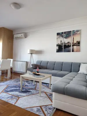 a living room with a couch and a table at Spa apartman Iva in Banja Luka