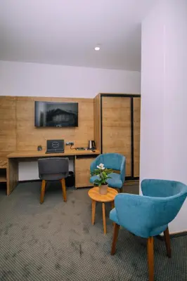 an office with two chairs and a desk with a computer at Hotel Salis in Tuzla