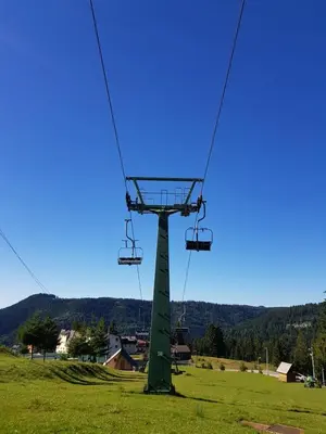 a chair lift in a field with a green field at Vlasicka avantura Eko Fis 509 in Vlasic