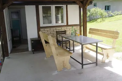 a table and two benches on a patio at Ravne Apartman 2 in Visoko