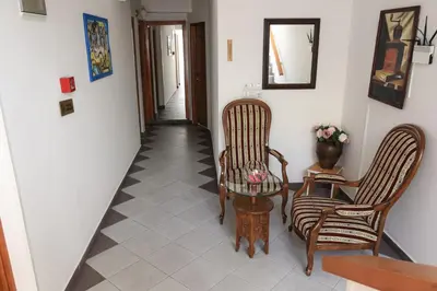 a hallway with two chairs and a table at Pansion Centar in Tuzla