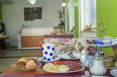 a table with plates of food on top of it at Pansion Centar in Tuzla