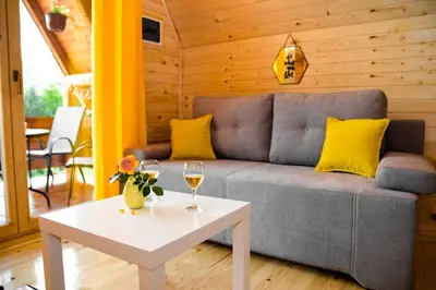 a living room with a couch and a table with wine glasses at Cottage Lana in Jajce