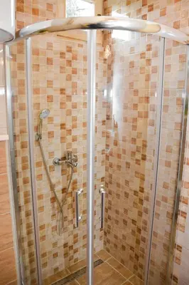 a shower in a bathroom with a glass door at Cottage Lana in Jajce