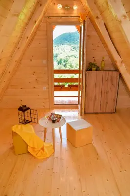 a room with a table and a window in a attic at Cottage Lana in Jajce