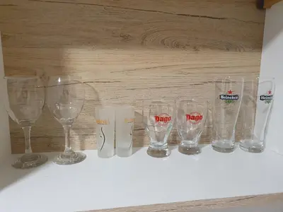 a row of wine glasses sitting on a shelf at Garsonjera u centru Prnjavor in Prnjavor