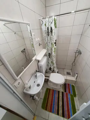 a bathroom with a toilet and a sink and a mirror at Garsonjera u centru Prnjavor in Prnjavor