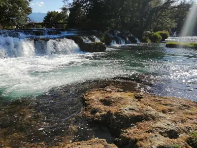 a waterfall with a rainbow in the background at Apartman Dzenis in Bihać