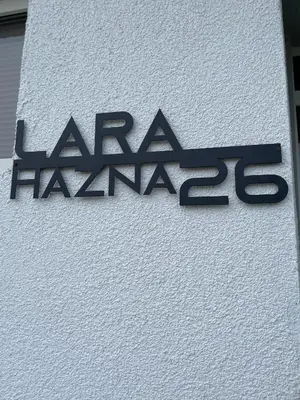 a sign on the side of a building at Sobe Lara in Gradačac