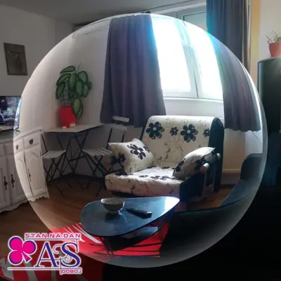 a living room with a chair and a table at Stan na dan AS Doboj in Doboj