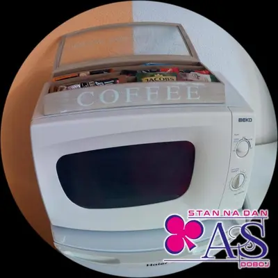 a white microwave with a box on top of it at Stan na dan AS Doboj in Doboj