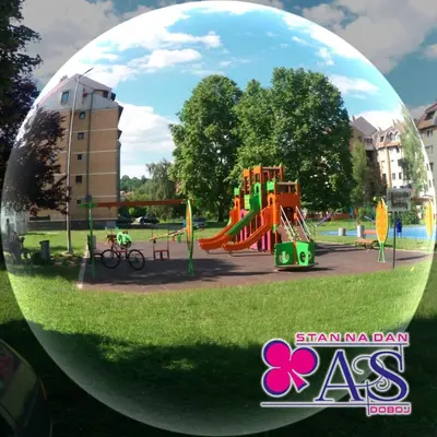 a playground in a park with a glass ball at Stan na dan AS Doboj in Doboj