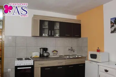 a kitchen with a sink and a microwave at Stan na dan AS Doboj in Doboj