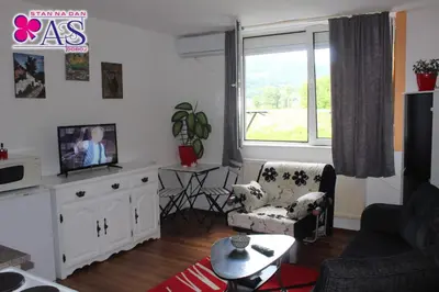 a living room with a couch and a tv at Stan na dan AS Doboj in Doboj