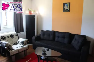 a living room with a couch and a table at Stan na dan AS Doboj in Doboj