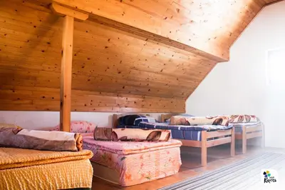a room with several couches and a wooden ceiling at Adria in Kupres