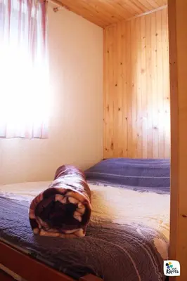 a bedroom with a bed with a blanket on it at Adria in Kupres