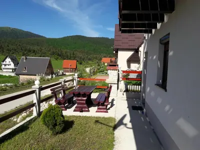 a group of benches sitting on the side of a building at Adria in Kupres