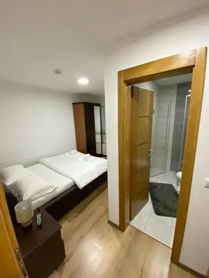 a bedroom with a bed and a walk in shower at Motel OAZA in Cazin