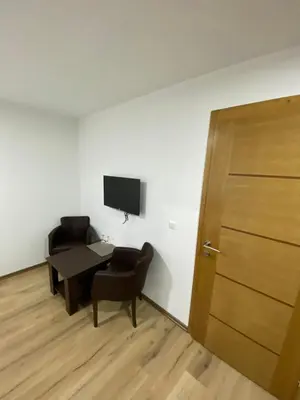 a room with a table and a chair and a door at Motel OAZA in Cazin