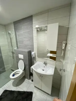 a bathroom with a toilet and a sink at Motel OAZA in Cazin