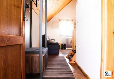 a hallway of a tiny house with a stairway at Apartman Adria 2 in Kupres