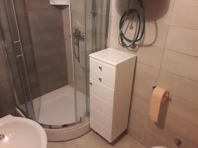 a bathroom with a shower and a toilet and a sink at Apartman Adria 2 in Kupres