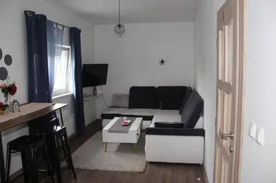 a living room with a couch and a table at Apartman ANA Livno - biker friendly in Livno