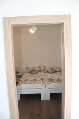 a reflection of a bed in a mirror at Apartman ANA Livno - biker friendly in Livno