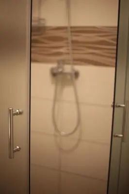 a shower in a bathroom with a glass door at Apartment Perviz in Bihać