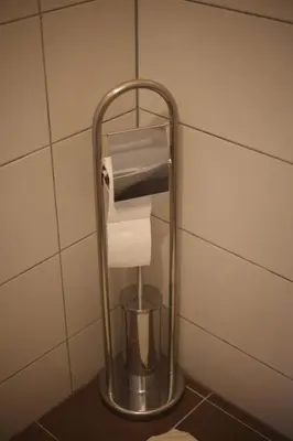 a roll of toilet paper in a holder in a bathroom at Apartment Perviz in Bihać