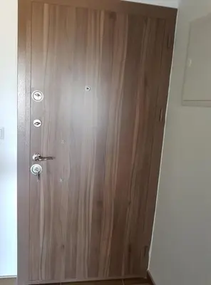 a wooden door with a handle in a room at Apartment Perviz in Bihać
