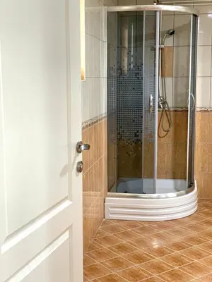 a shower with a glass door in a bathroom at Apartmani GO Bugojno in Bugojno