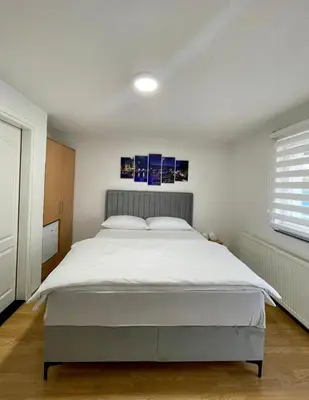 a bedroom with a large white bed in it at Apartmani GO Bugojno in Bugojno