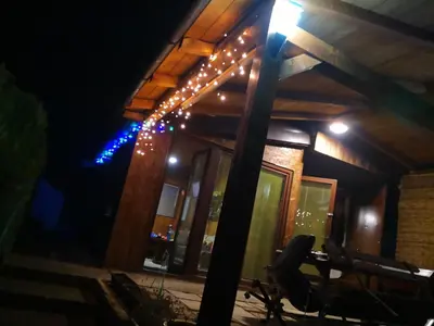 a house with lights on the side of it at night at Holiday Home Dragon in Visoko