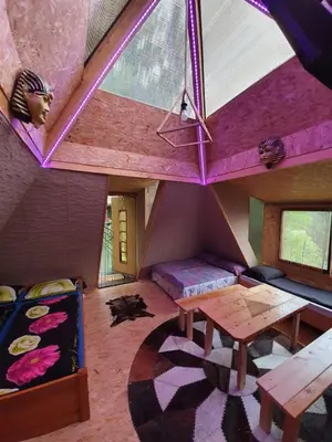 a room with a table and a couch and a room with a tent at Pyramid in Visoko