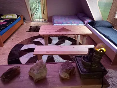 a room with a picnic table and a couch at Pyramid in Visoko